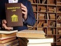 BANKRUPTCY LAW book in the hands of a attorney. SinceÃÂ bankruptcy lawsÃÂ aim at the liquidation or rehabilitation of insolvent Royalty Free Stock Photo